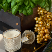 Emerald Berries scented candle in clear glass jar with gold label
