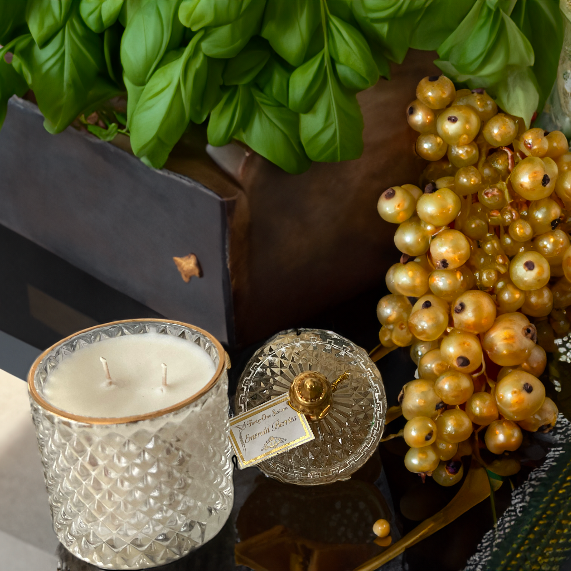 Emerald Berries scented candle in clear glass jar with gold label
