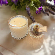 Moonflower Essence scented candle in clear glass jar with gold label
