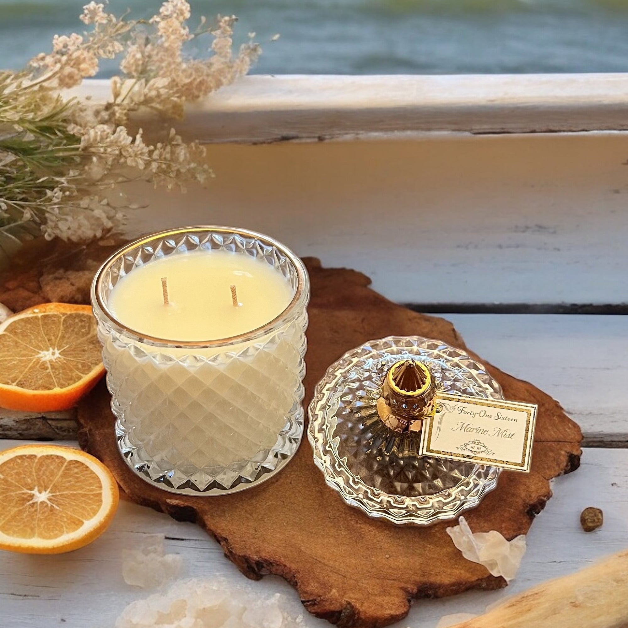 Marine Mist scented candle in clear glass jar with gold label
