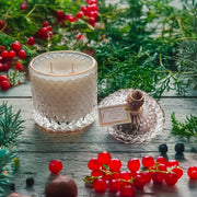 Fir and Frost scented candle in clear glass jar with gold label

