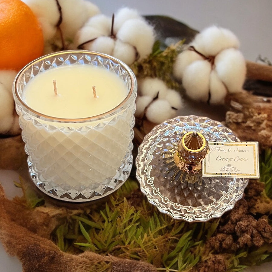 Orange Cotton scented candle in clear glass jar with gold label
