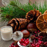 Berry Noel scented candle in clear glass jar with gold label
